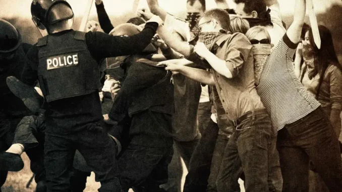 Police clashing with protestors in sepia tone.