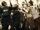 Police clashing with protestors in sepia tone.