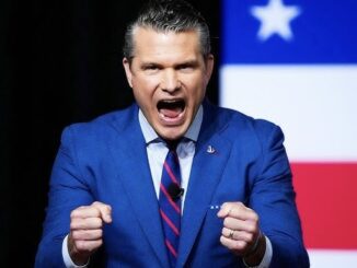 Man in blue suit shouting with clenched fists