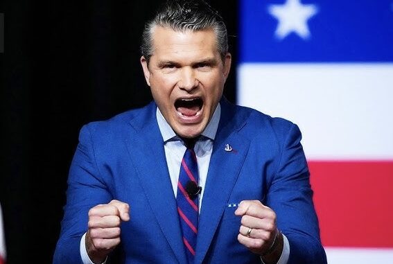 Man in blue suit shouting with clenched fists