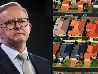 Man beside aerial view of suburban houses.