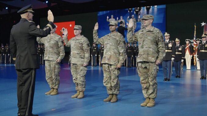 Military personnel taking an oath on stage. Military personnel taking an oath on stage.