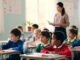 Children attentively listening in a classroom.
