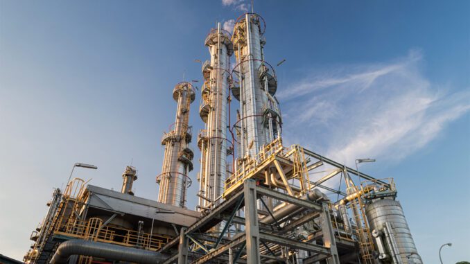 Industrial refinery towers against blue sky. Industrial refinery towers against blue sky.