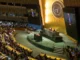 UN assembly hall with speaker at podium.