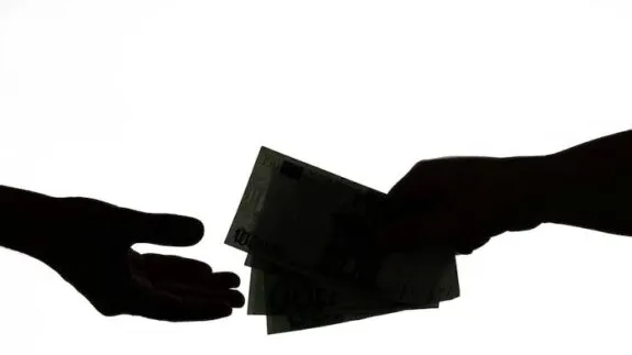 Silhouette of hands exchanging money.