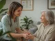 Smiling nurse holding an older woman's hands