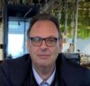 Man wearing glasses in an indoor setting.