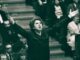 Conductor passionately leading an orchestra performance.