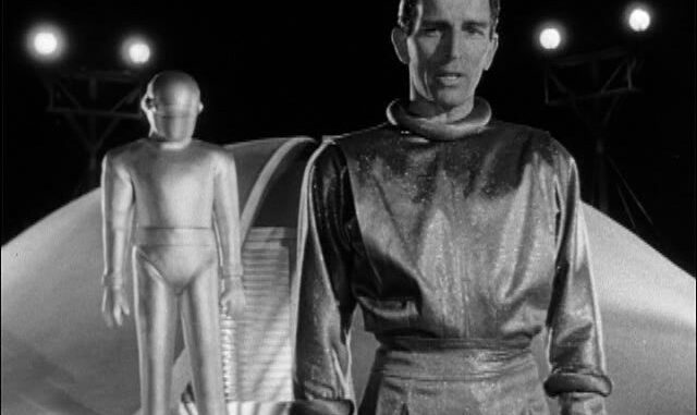 Man and robot in futuristic setting, black-and-white.