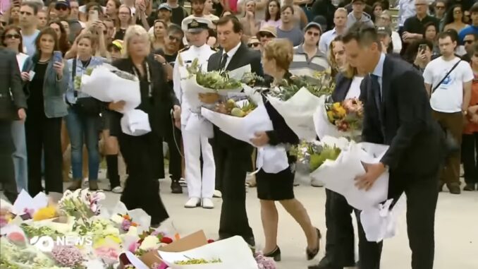 People laying flowers at a memorial ceremony. People laying flowers at a memorial ceremony.