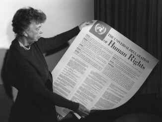 Person holding Universal Declaration of Human Rights.