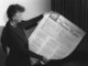 Person holding Universal Declaration of Human Rights.