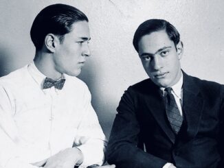Two men in suits, one with bowtie.