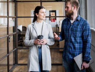 Two people talking in a modern office.