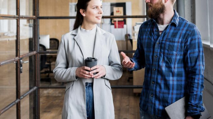 Two people talking in a modern office.
