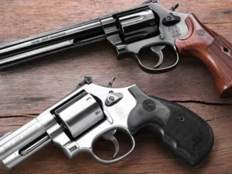 Two revolvers on a wooden surface.