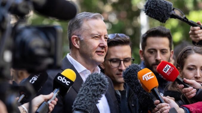 Man speaking to reporters with microphones outside. Man speaking to reporters with microphones outside.