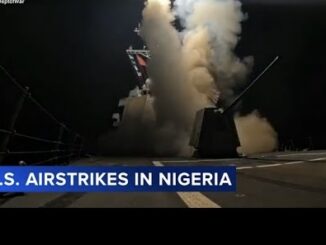 Naval destroyer launching missile over deck