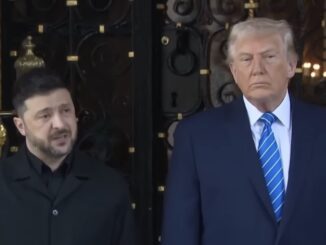 Two men standing in formal attire indoors.