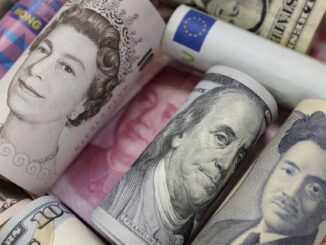 Rolled international currency bills, various denominations.