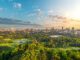 City skyline and golf course at sunset.