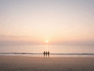 Sunset beach scene with four people standing.