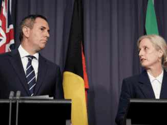 Two officials speaking at a press conference.