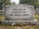 Gravestone with political message in cemetery.