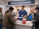 People at a needle exchange service counter.