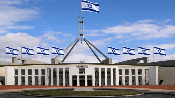 Parliament House with multiple Israeli flags flying.