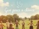 People holding hands in a grassy field.