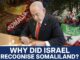 Politician signing document, Somaliland recognition question.