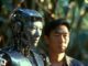 Human and robot standing in forest setting.