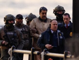 Group of officers escorting a man.