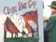 Protest sign reading "Close Pine Gap" held.
