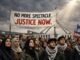 Protesters holding Justice Now banner at rally.