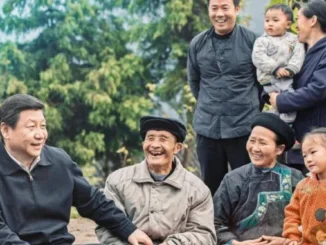 Group of people smiling in an outdoor setting.