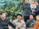 Group of people smiling in an outdoor setting.