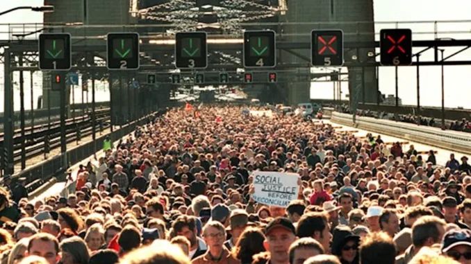 Crowd marching on bridge during protest. Crowd marching on bridge during protest.