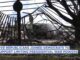 Damaged structure with news caption overlay.