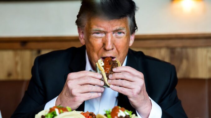 Man eating tacos at a restaurant table.