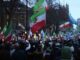 Protesters waving flags during a demonstration.