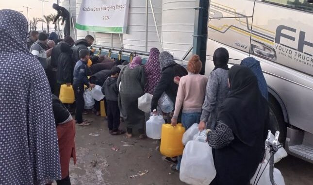 People collecting water from large containers. People collecting water from large containers.