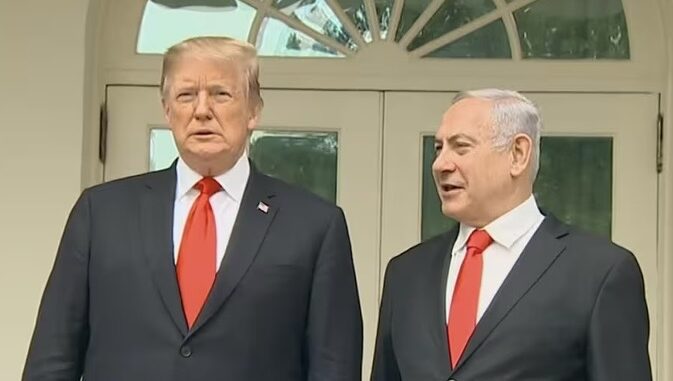 Two men in suits standing outside building.