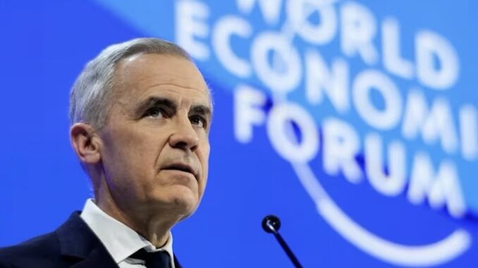 Gray-haired man addressing World Economic Forum stage