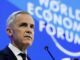 Gray-haired man addressing World Economic Forum stage
