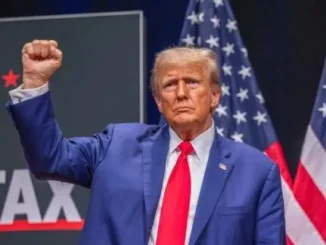 Politician in blue suit with raised fist