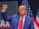 Politician in blue suit with raised fist