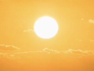 Bright sun in a clear orange sky.